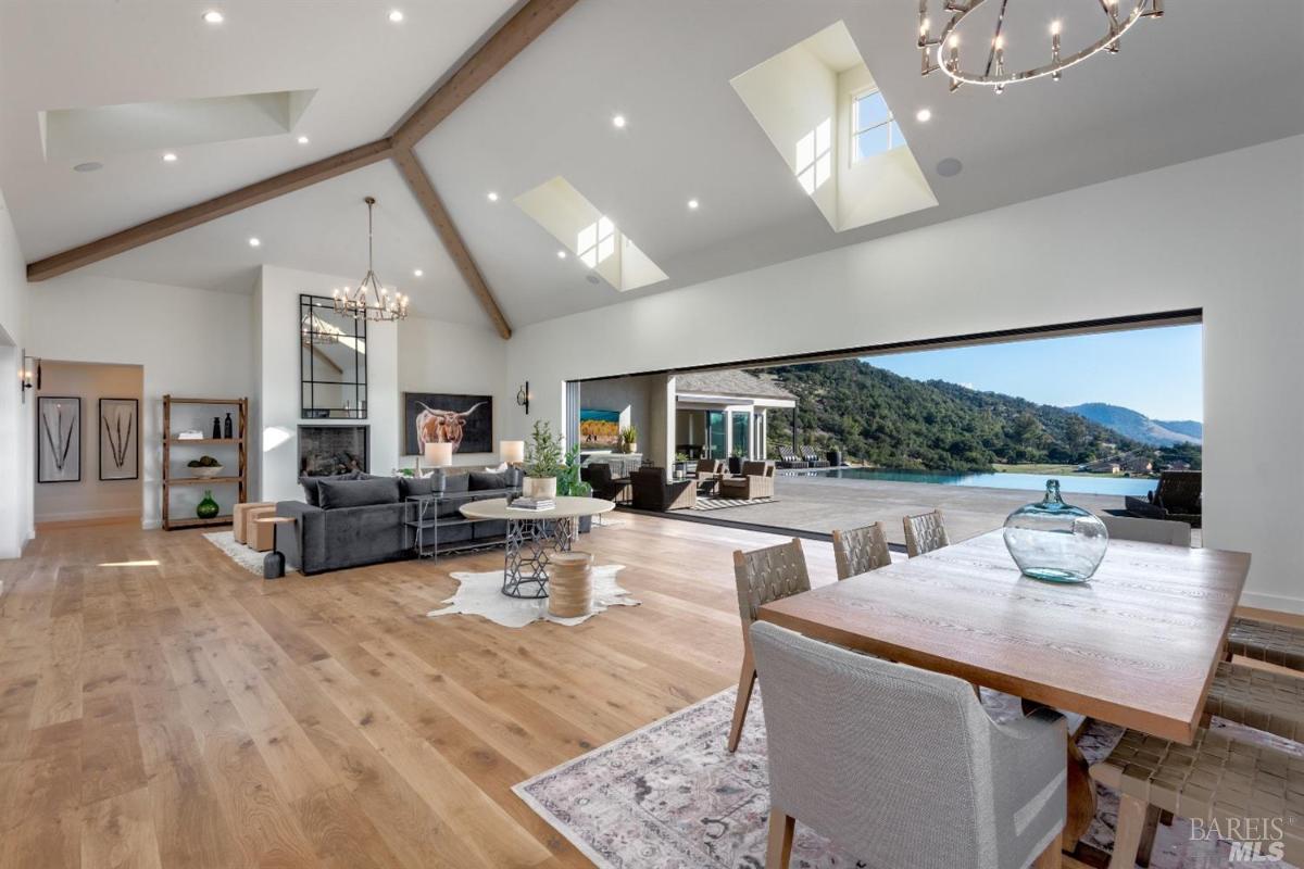 Dining room with a chandelier and wood flooring.