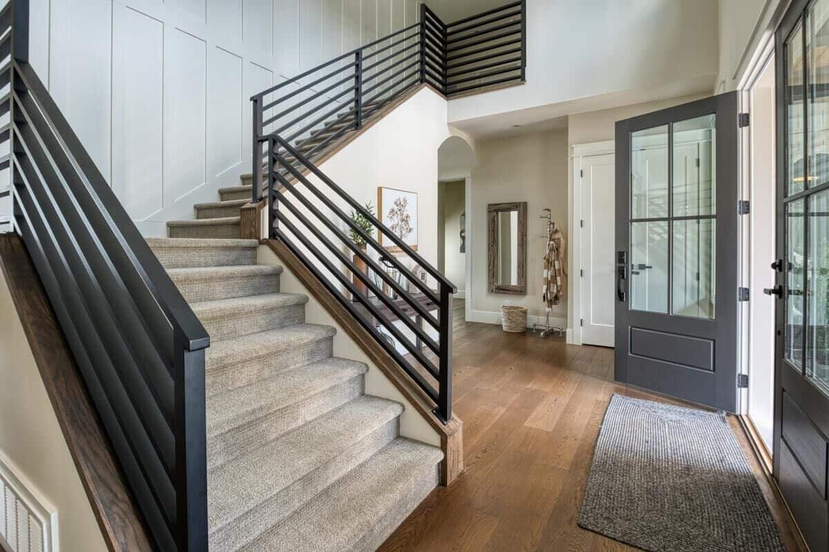 Foyer with a French entry door and a carpeted staircase leading to the upstairs bedrooms.