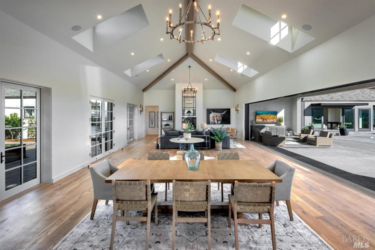 Dining room with a chandelier and wood flooring.