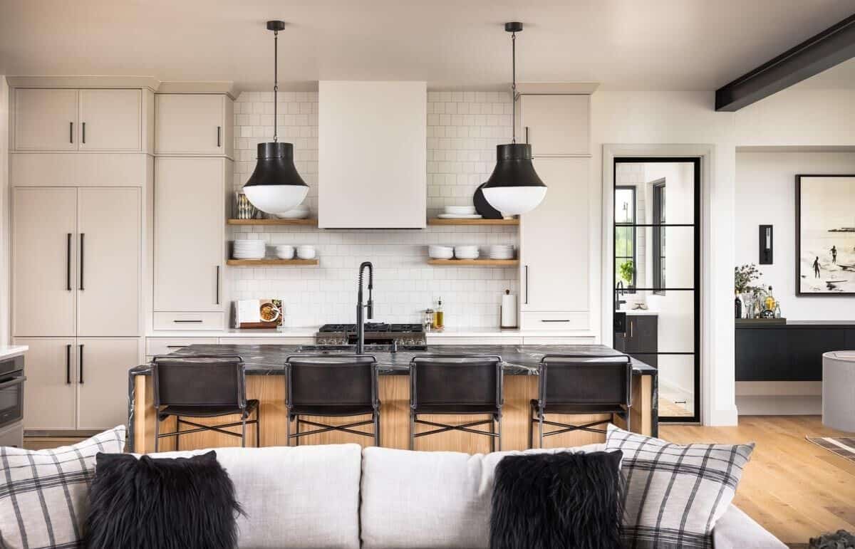 Kitchen with white cabinetry, floating shelves, and a breakfast island with four seating.