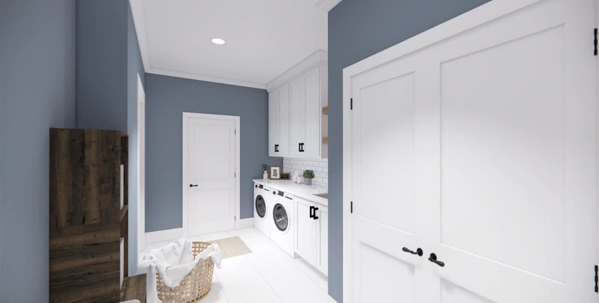 Laundry room with white cabinets, front-load appliances, and a marble countertop.