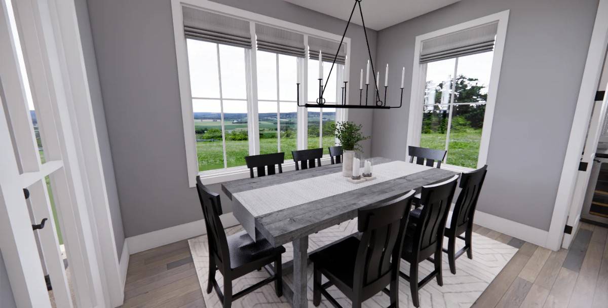 Dining area with black chairs and a rustic table topped with a wrought iron chandelier.