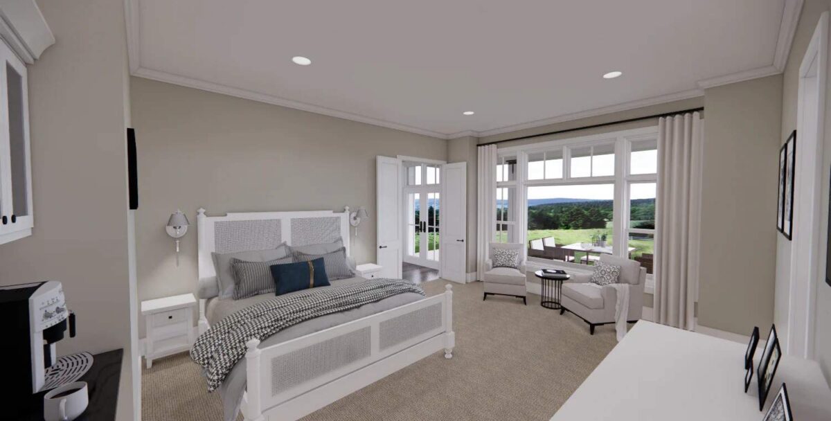 Primary bedroom with white furnishings and a sitting area by the window.