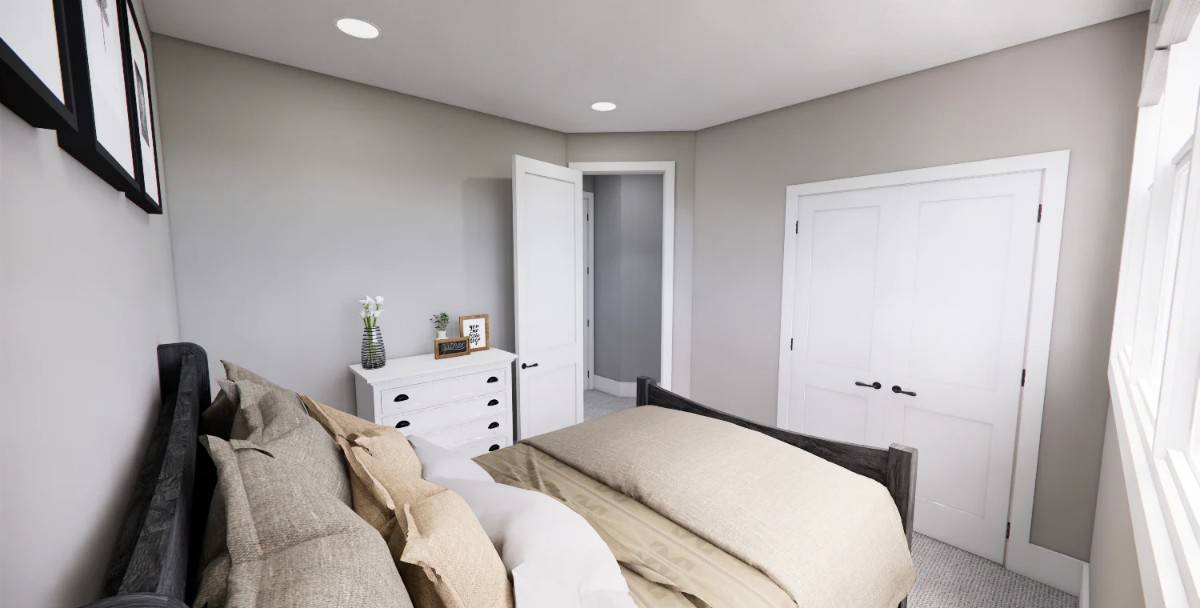 Secondary bedroom with a dark wood bed, a white dresser, and a built-in wardrobe concealed behind double doors.