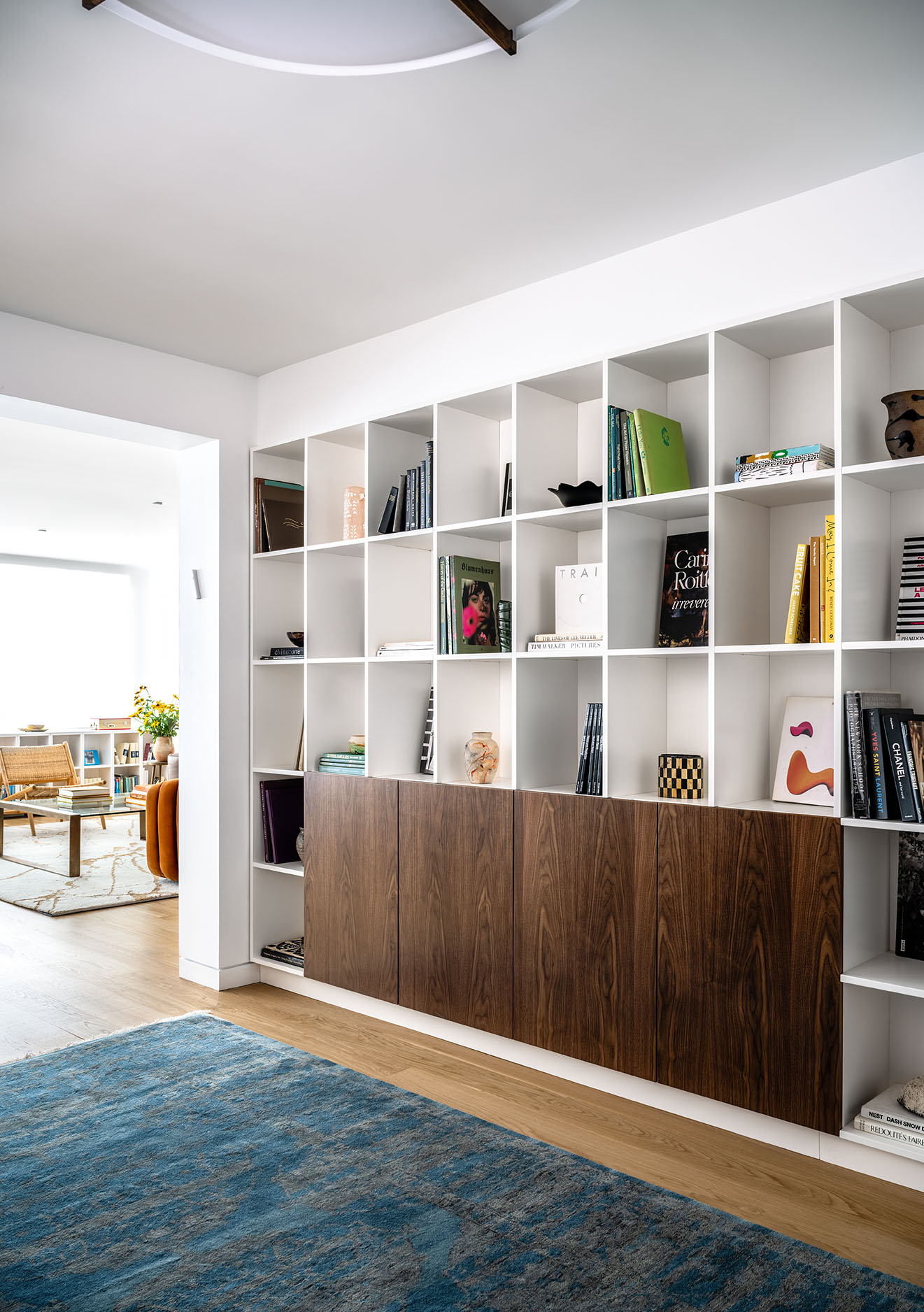 Floor-to-ceiling white bookshelf in 2,500 sq ft mid-century modern New York City apartment