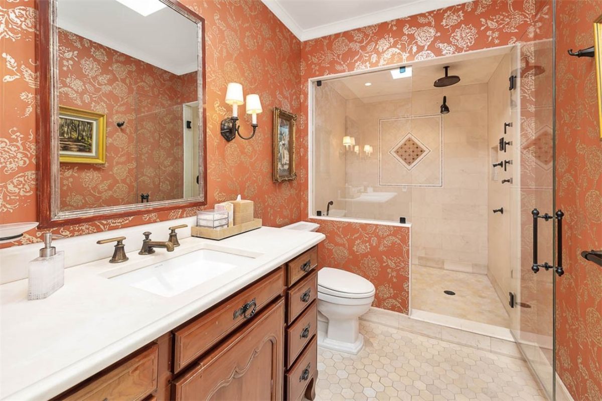 Bathroom with a sink, toilet and a walk-in shower.