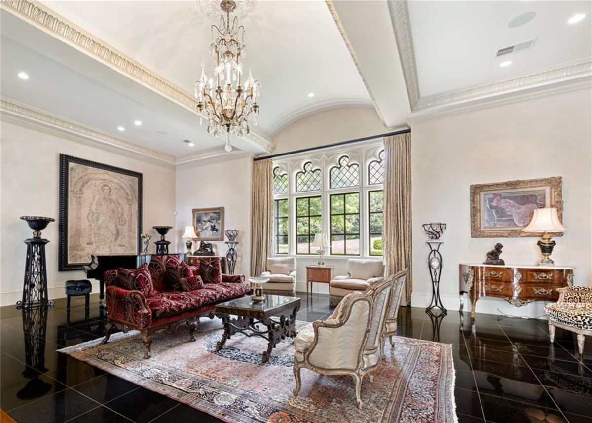 Living room with a chandelier and glass windows. 