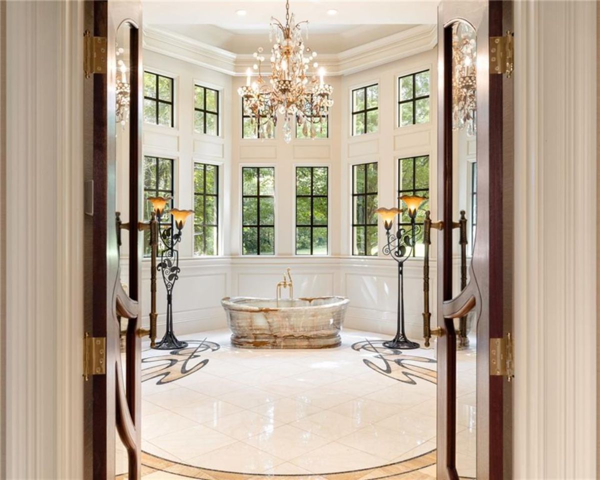 Bathroom with a chandelier and a soaking tub. 