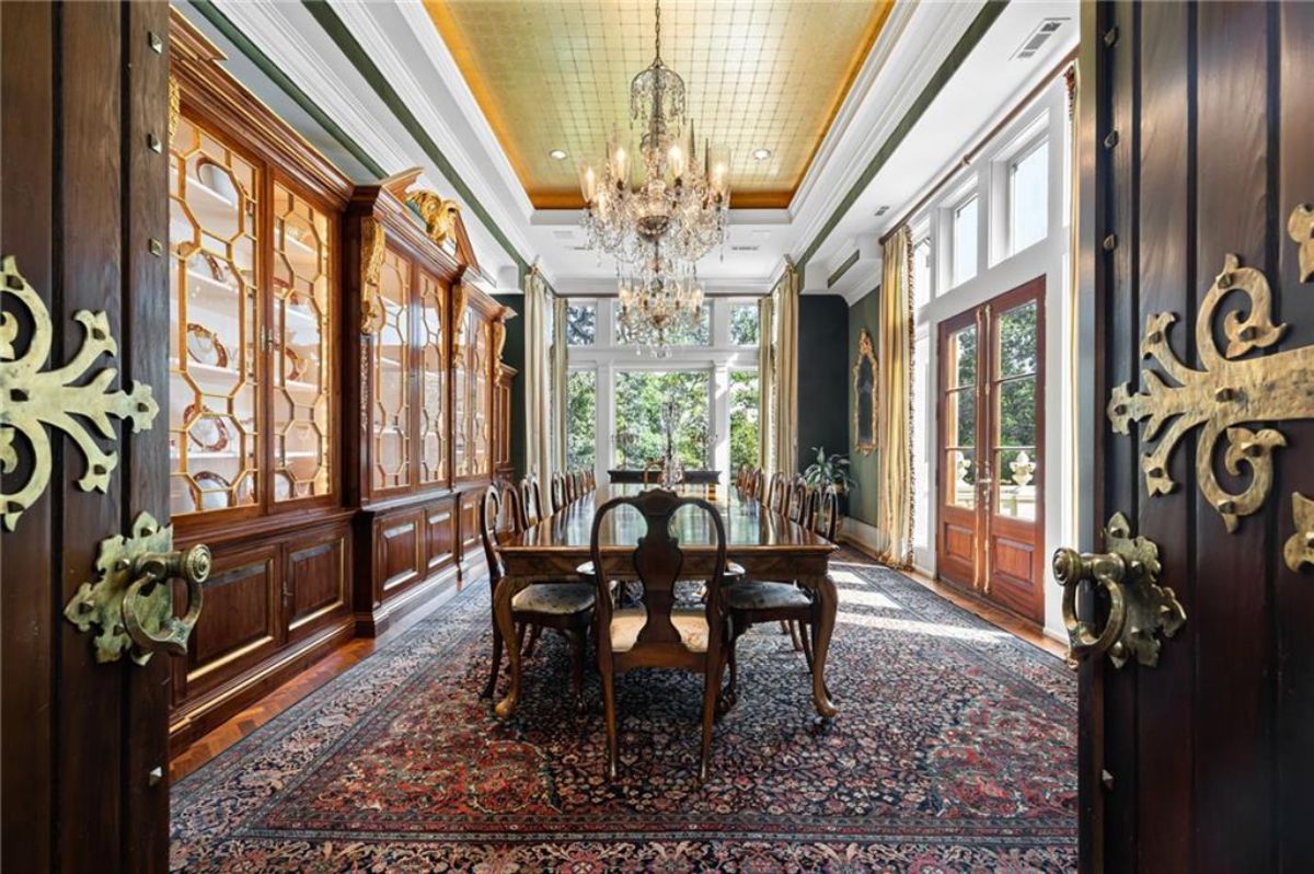 Dining room with a large table and a chandelier.