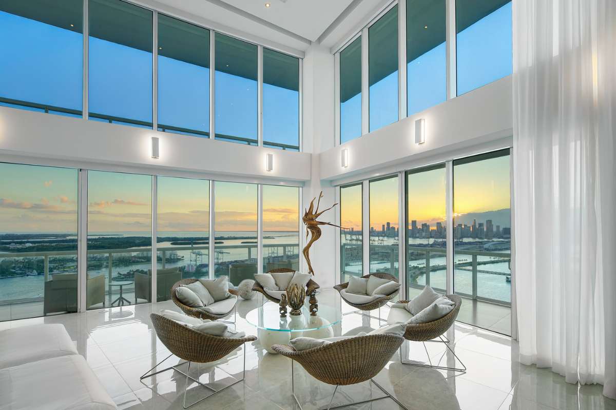 A living room with a central table, surrounded by comfortable chairs