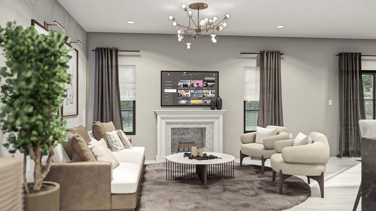 Great room with beige sofas, a round coffee table, and a fireplace topped with a wall-mounted TV.