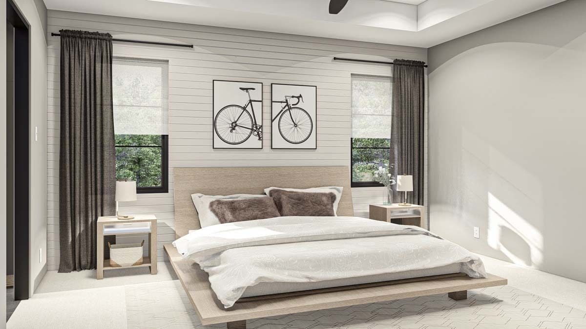 Primary bedroom with a tray ceiling and a wooden bed flanked by matching nightstands.