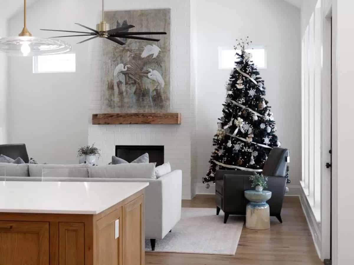 Living room with a sectional sofa and a fireplace topped by a floating shelf.