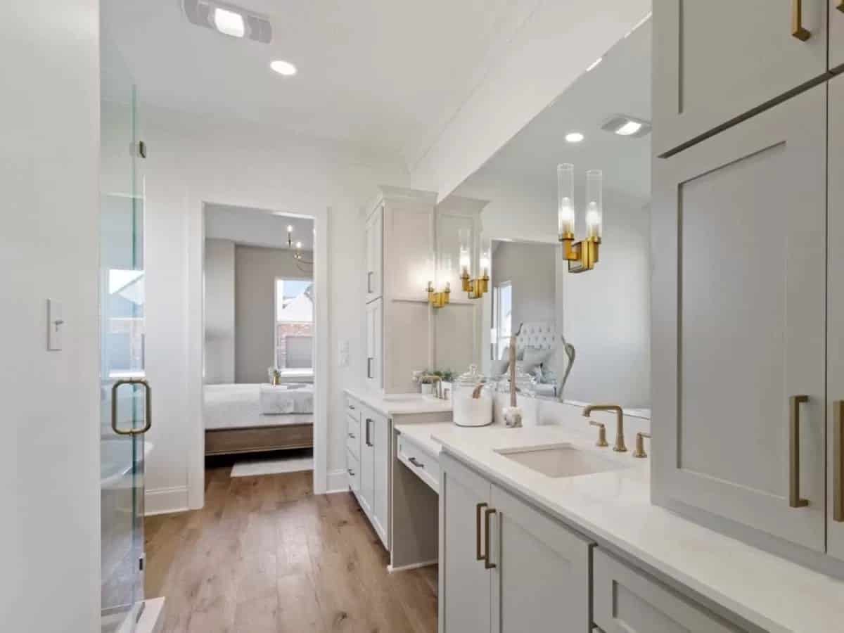 The primary bathroom includes a dual sink vanity with a makeup counter in the middle.