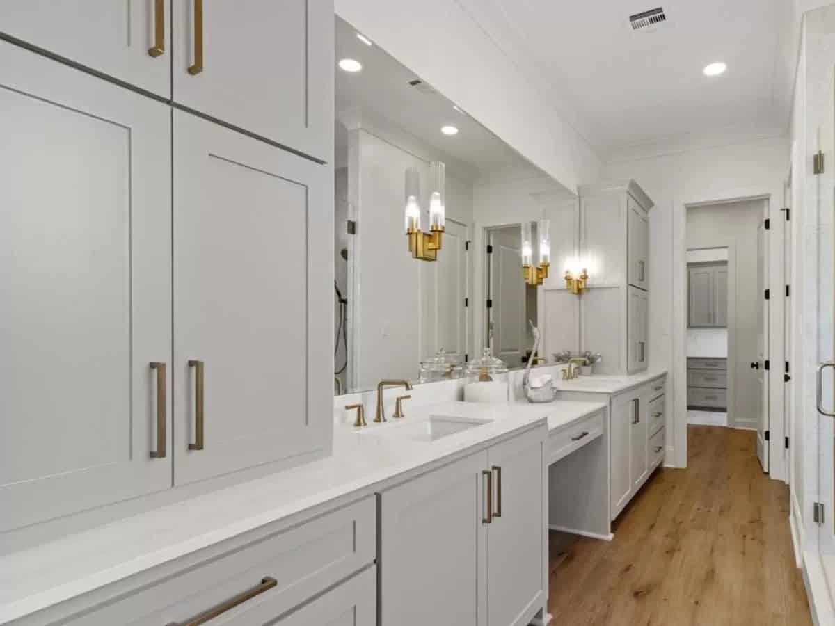 Primary vanity with large cabinets, two sinks, and a makeup counter.