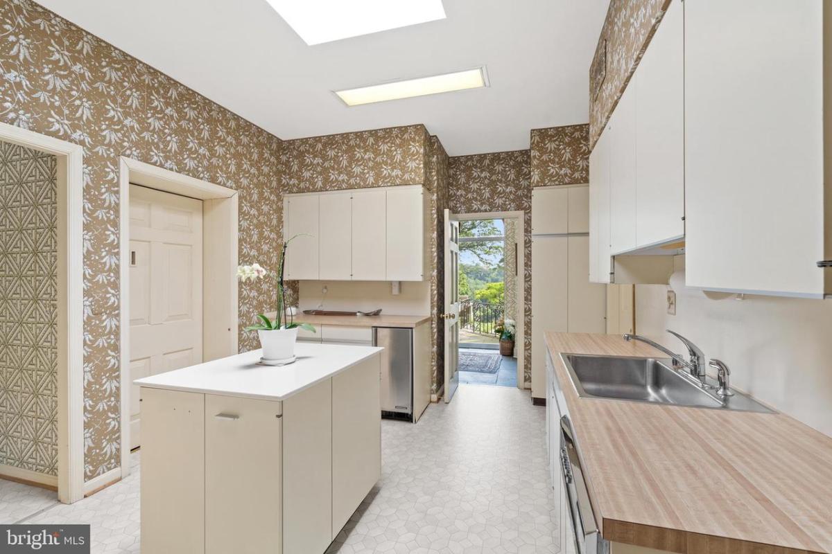 Kitchen with custom cabinets and skylights.