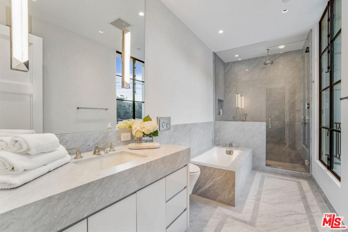 Bathroom with a sink, soaking tub and a shower.