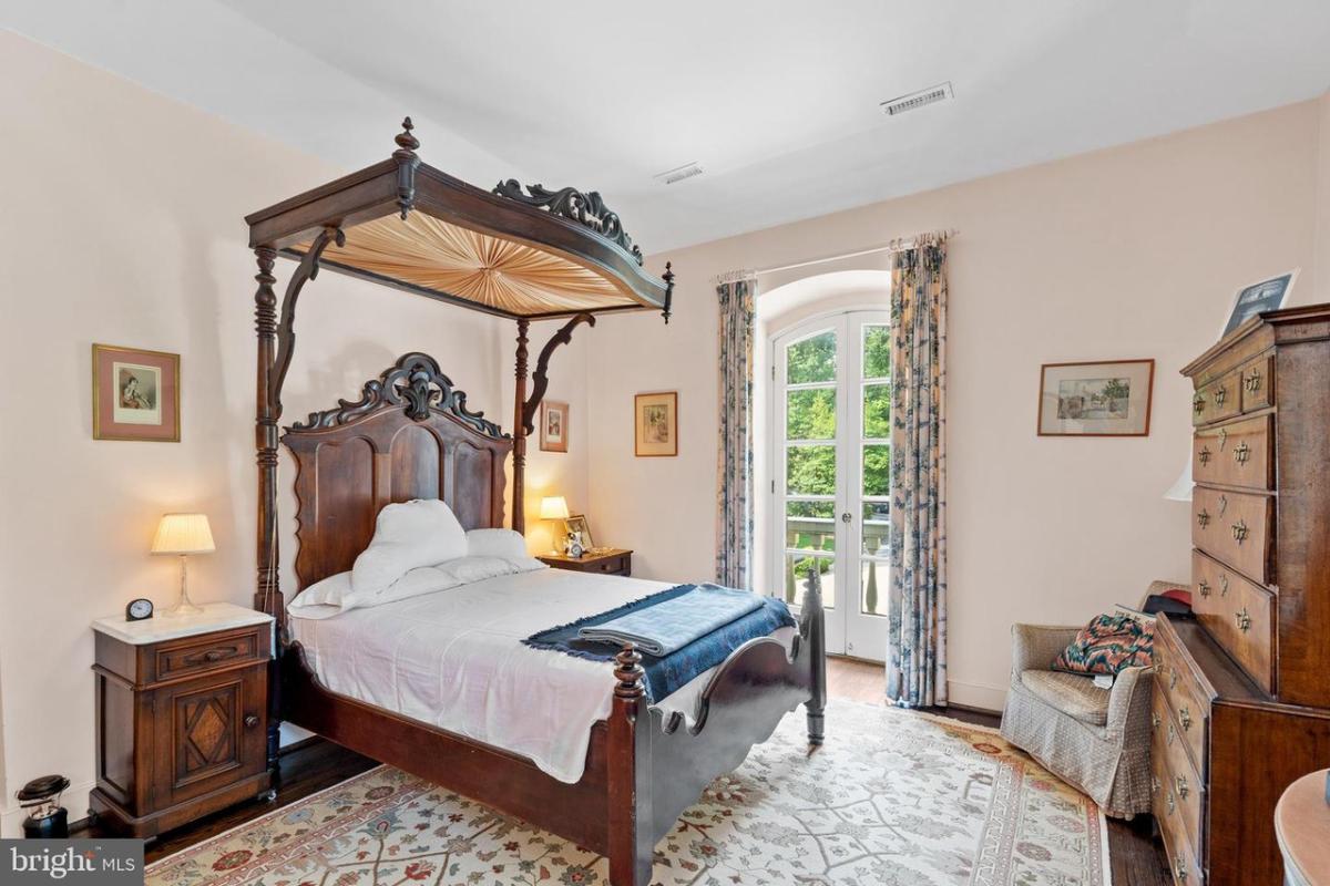 Bedroom with a large bed and French doors.