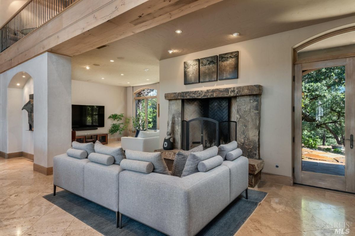 Living room with couches, fireplace and custom lights.