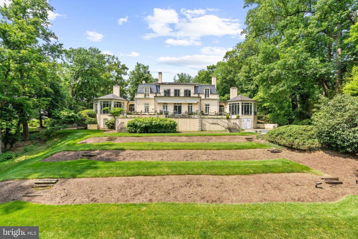 Rear view of the mansion with large lawn.