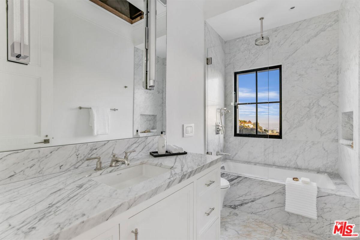 Bathroom with a sink, soaking tub and a shower.