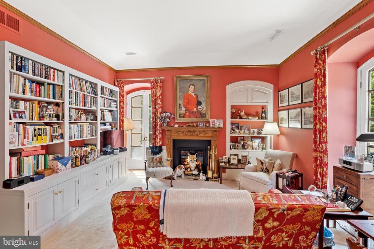 Reading nook with bookshelves and a fireplace.