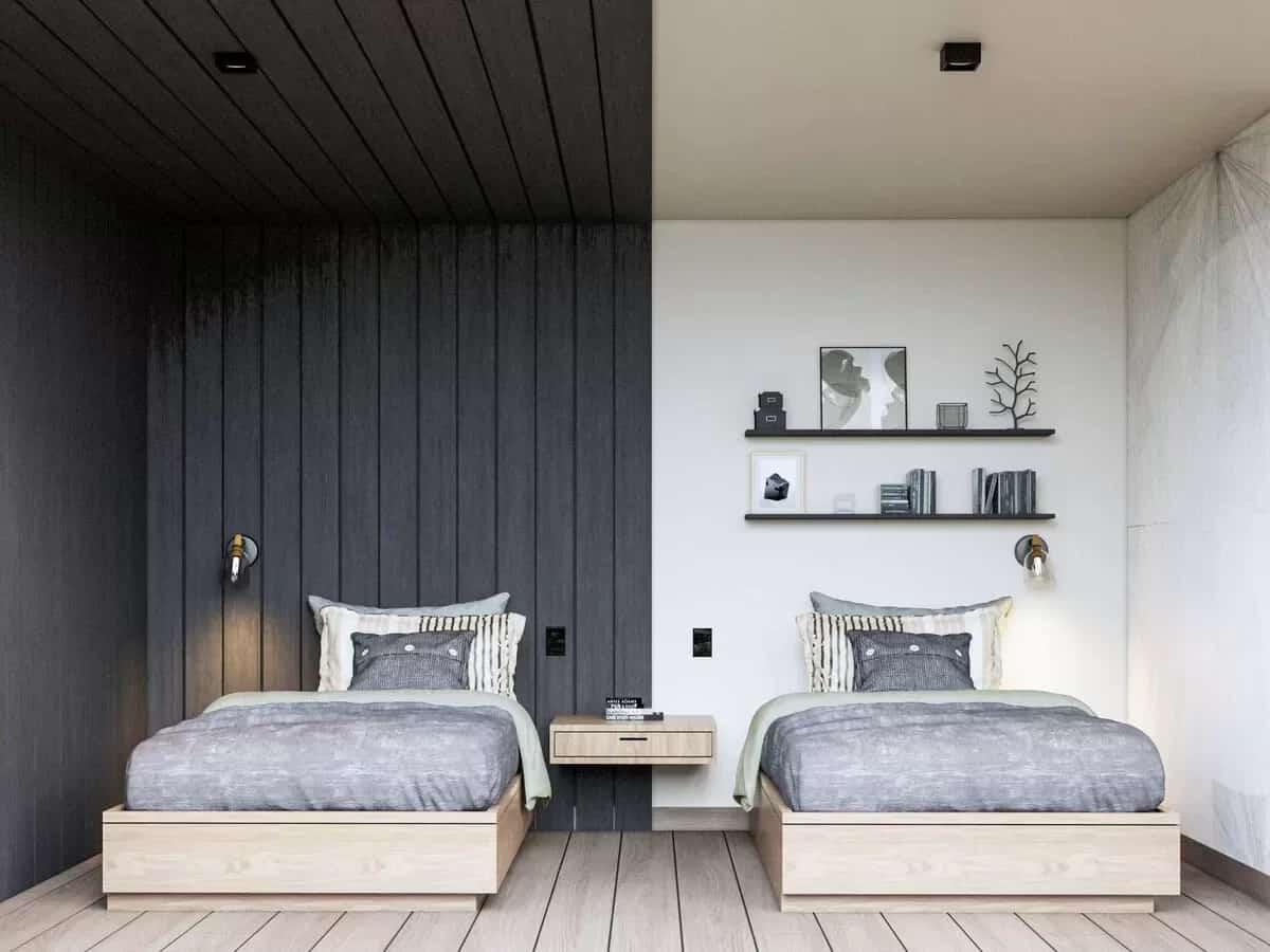 Bedroom with half beadboard walls and two beds over the wide plank flooring.