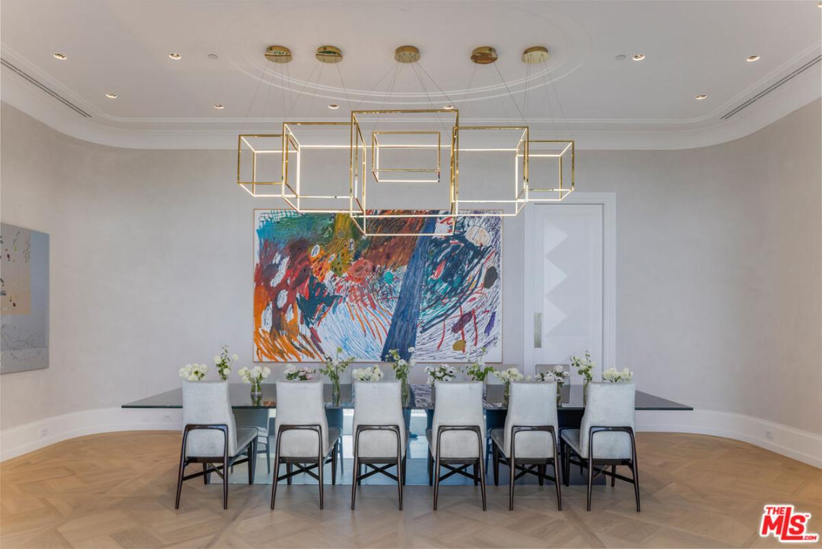 Dining room with a large table and custom lights.