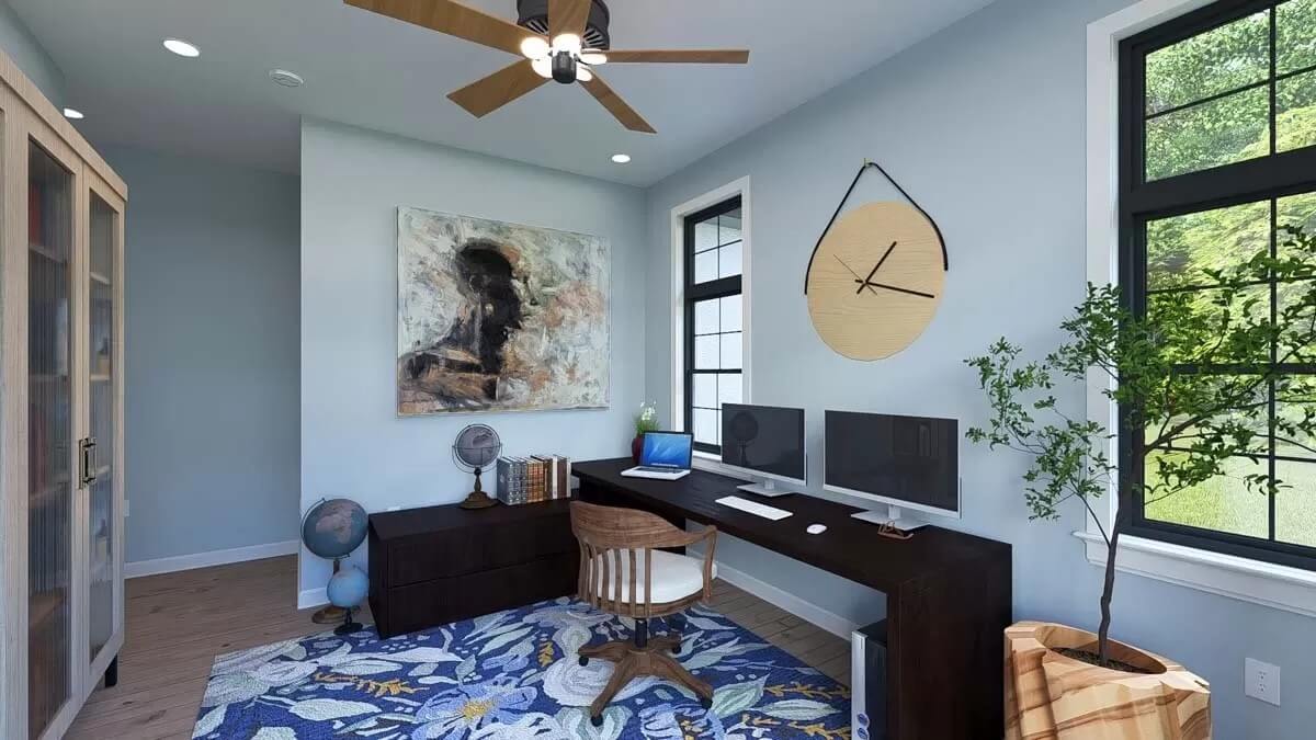 Office with a display cabinet and a dark wood desk paired with a cushioned chair.