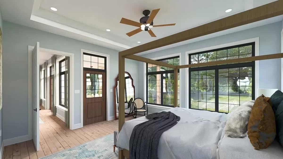 The primary bedroom includes large windows and a glazed door that opens to a covered porch.