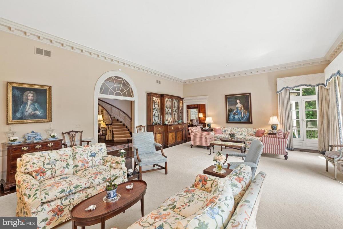 Living room with French doors and carpet flooring.