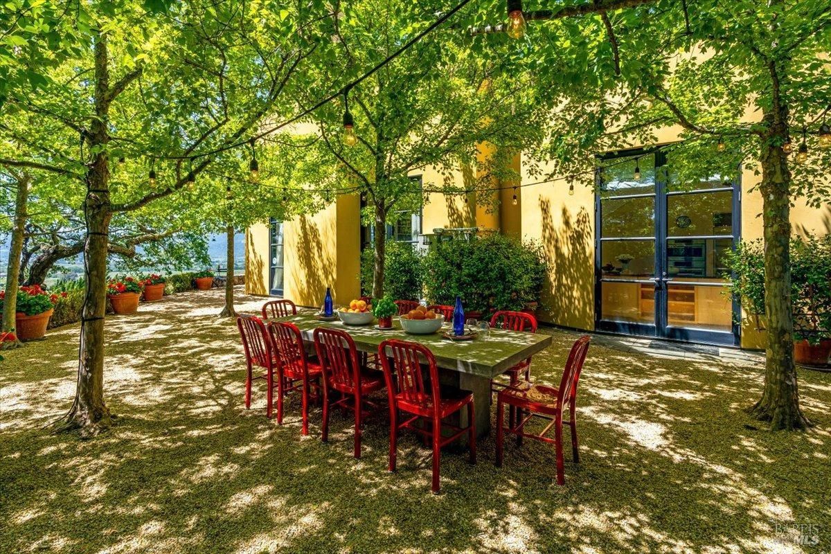 Outdoor dining with a large table and chairs.