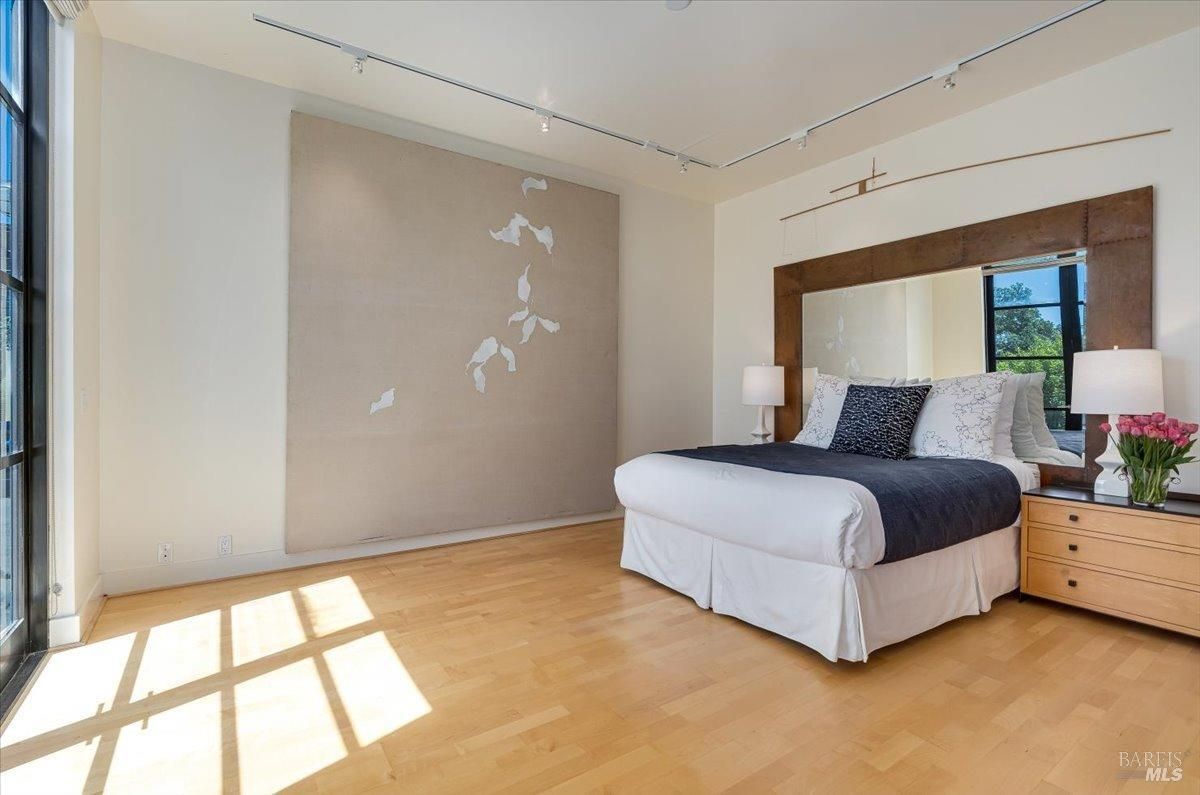 Bedroom with a large bed and a large mirror.