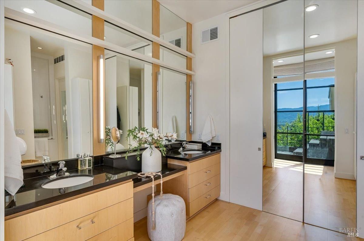 Bathroom with sinks and large mirror.