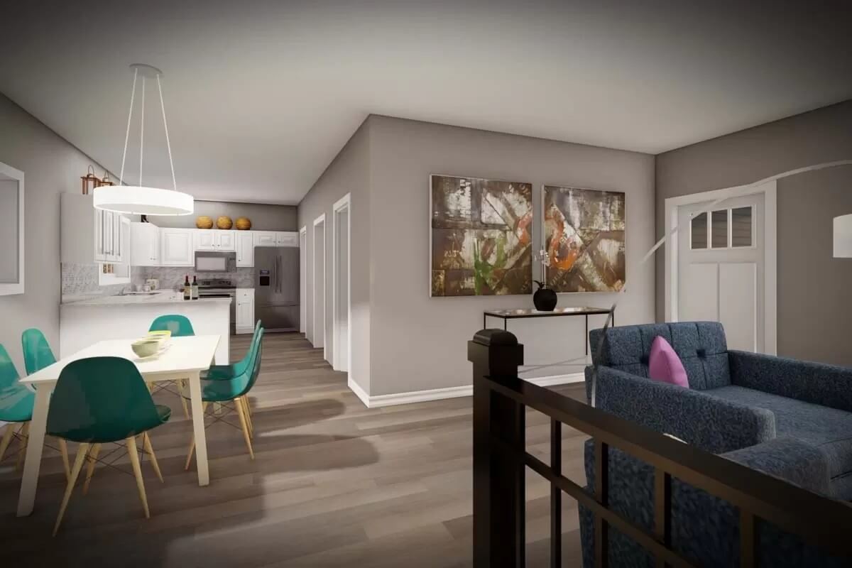 Dining area and kitchen with a peninsula bar and a white dining table surrounded by green chairs.