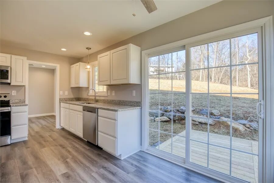 Kitchen and breakfast nook under a regular white ceiling.