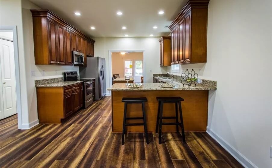 The kitchen includes a peninsula with bar seating.