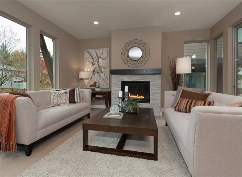 Great room with facing sofas, a wooden coffee table, and a fireplace.