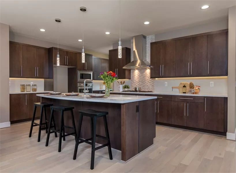 Kitchen with dark wood cabinets and a matching breakfast island.