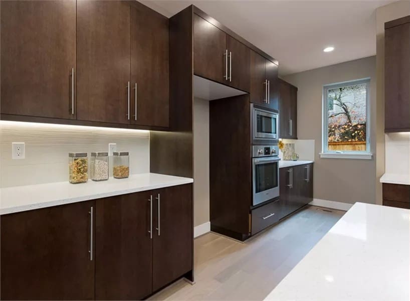 A picture window brings natural light into the kitchen.