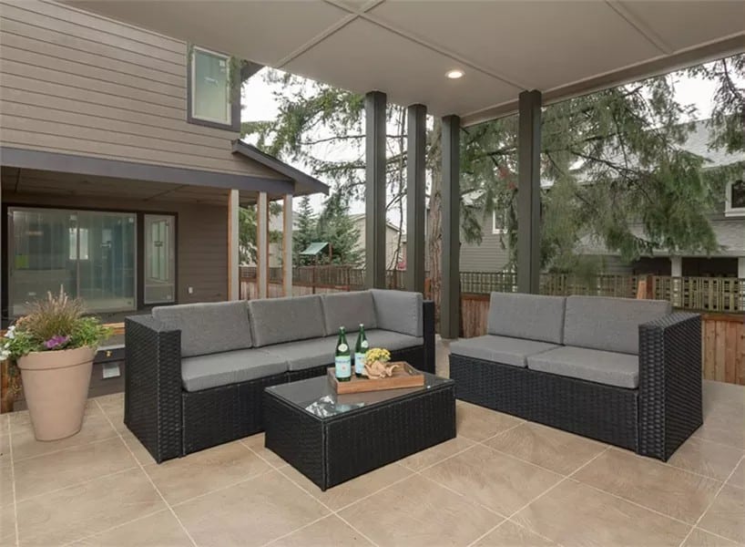 Outdoor living with wicker seats and a matching coffee table over the tiled flooring.