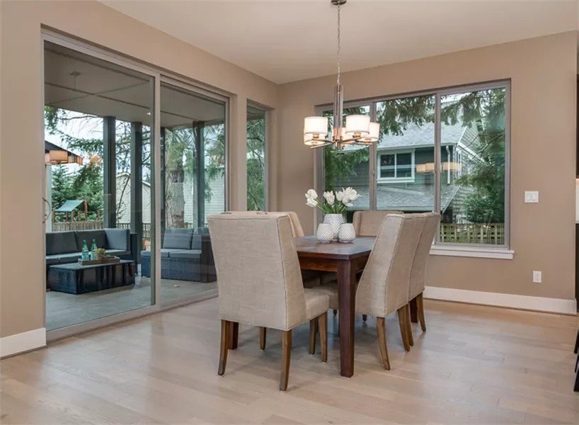 Dining room with a 6-seater dining set and sliding glass doors that open to a covered patio.