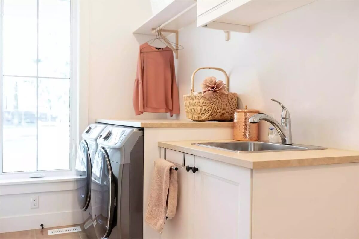 Laundry area with a large window and a utility sink.