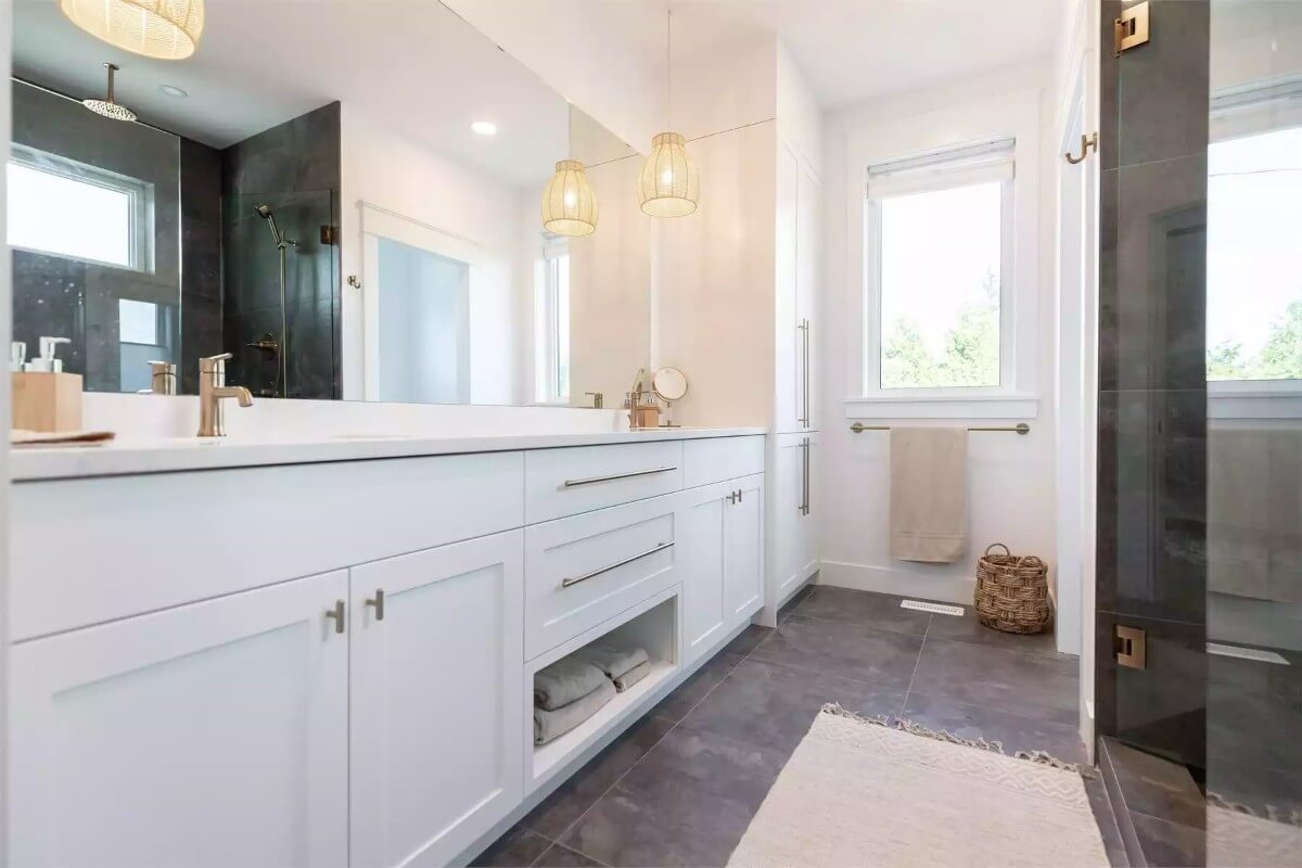 Primary bathroom with a dual sink vanity, and a walk-in shower.