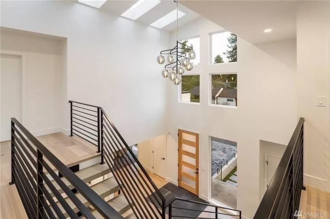 Second-level balcony with wrought iron railings and skylights.