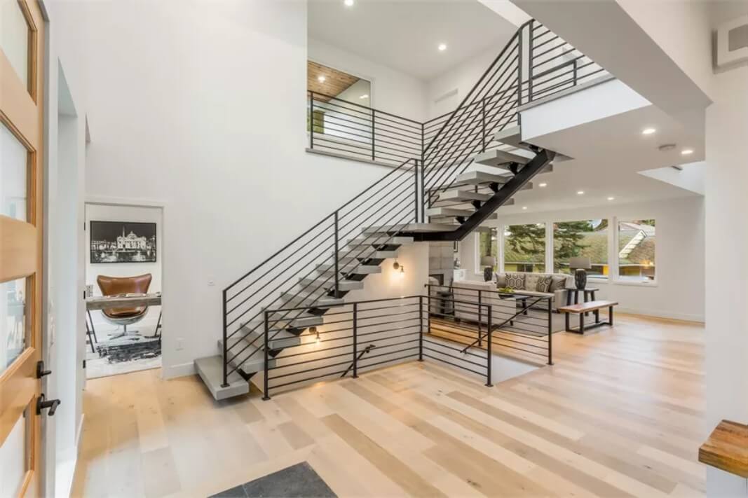 Foyer with hardwood flooring and a staircase leading to the sleeping quarters.