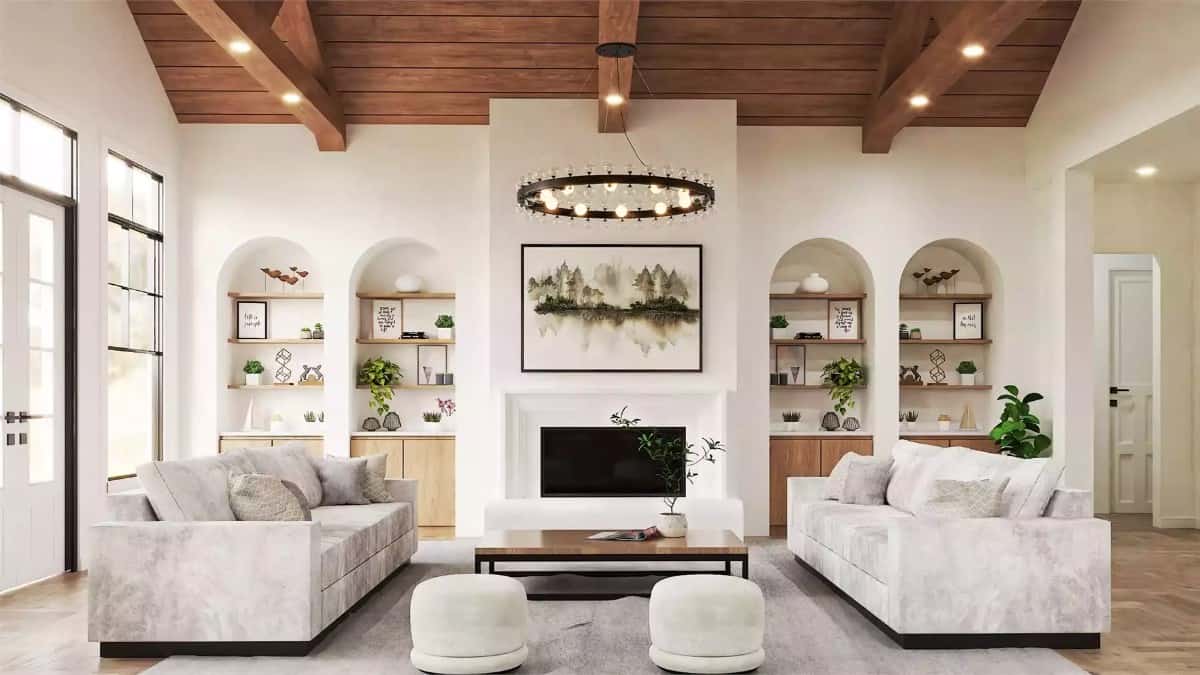 Great room with velvet sofas, and a fireplace flanked by arched insets.