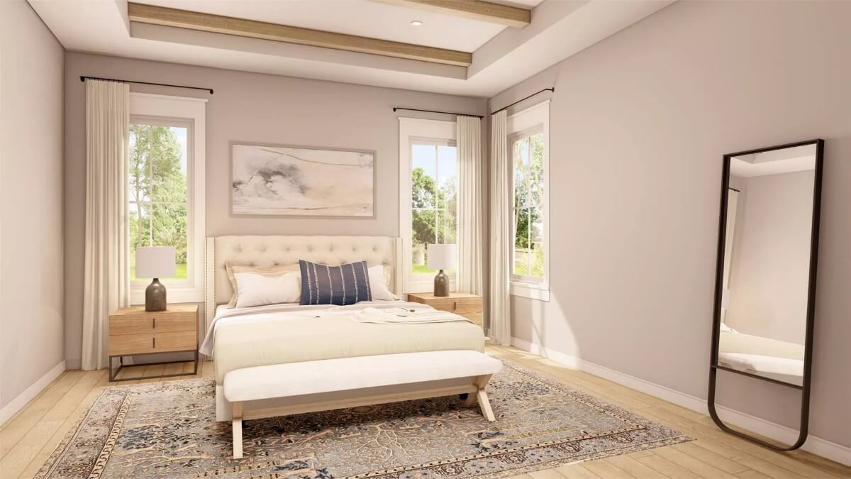 Primary bedroom with a tufted bed, a cushioned bench, and a tray ceiling accentuated with exposed beams.