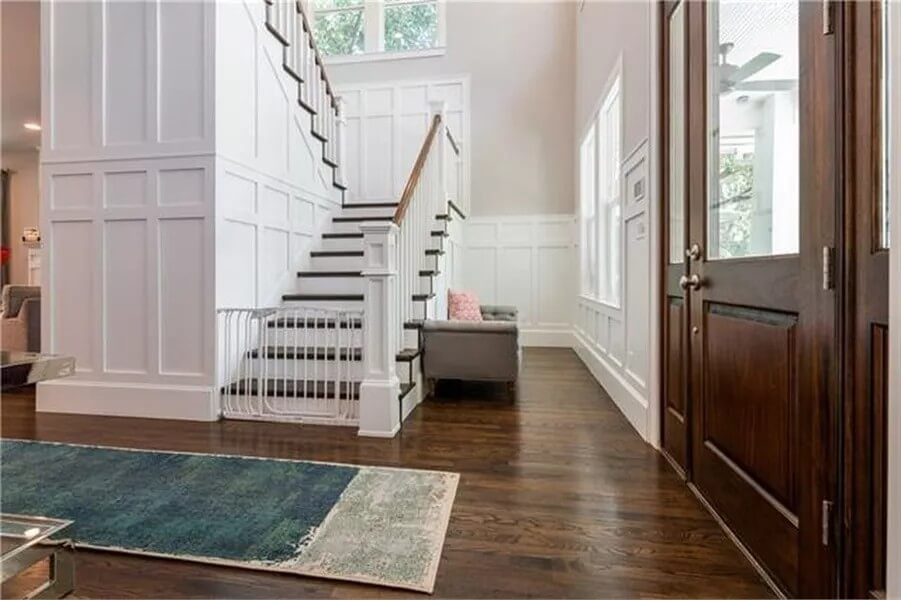 Foyer with a glazed front door and a staircase leading to the upstairs bedrooms.