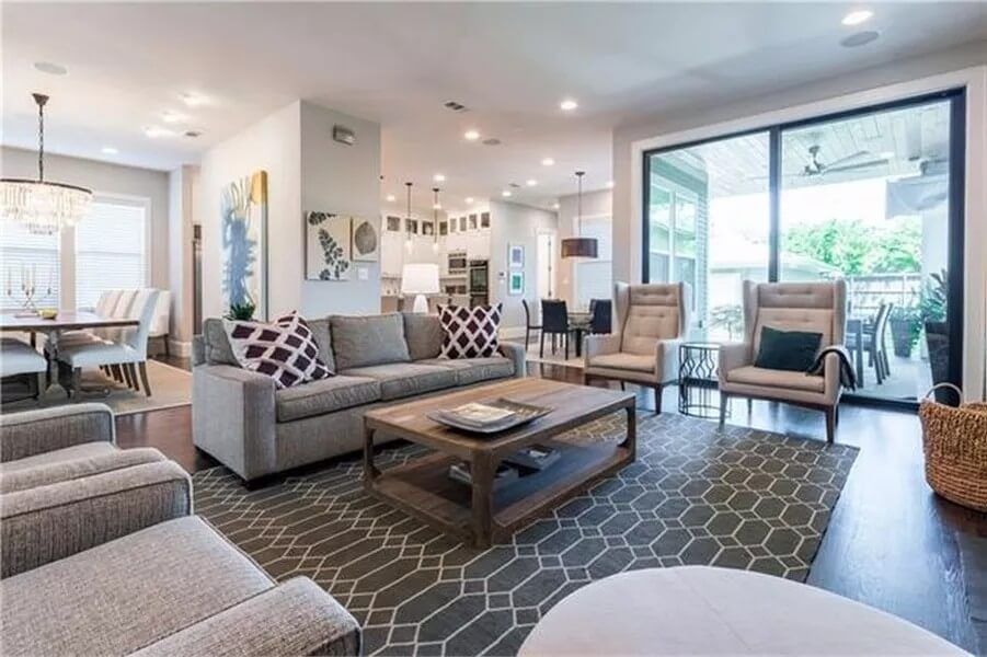 The family room includes a wooden coffee table over the patterned area rug.